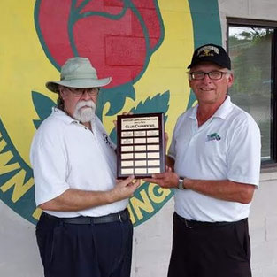 Photo of men's champions holding plaque.