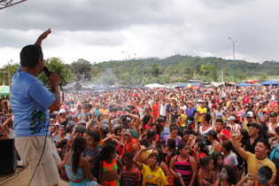 Multitud de turistas carnavaleros interactúan con uno de los cantantes que animaron el festival en el balneario de Platanales. Calceta, Ecuador.