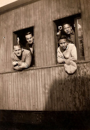 Train travelling in China - Herbert is on the left-rear with unknown man.