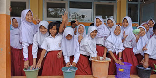 School children recycling used papers which are used for business cards 