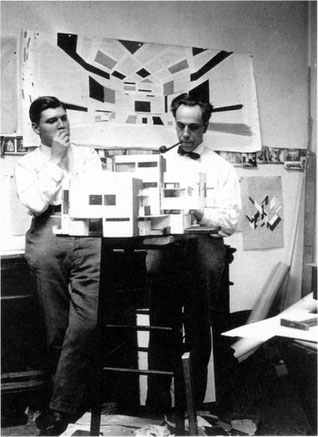 Theo van Doesburg (right) and C. van Eesteren (left) working on their architectural models in their studio in Paris. 1923