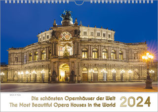 Ein Musik-Kalender: Die schönsten Opernhäuser der Welt - The Most Beautiful Opera Houses in the World. Dieser Titel steht in den unteren 20 % in Gold auf Weiß. Darüber sieht man die Dresdener Semperoper beleuchtet, vor tiefblauem Himmel.