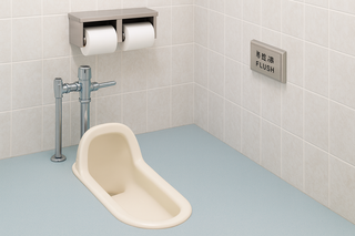 Traditional Japanese-style squat toilet in a public restroom.