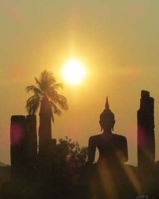 Here you can see a sunset with a buddha in front