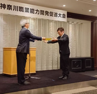 協会長から表彰を受ける本保氏。