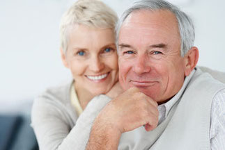 older couple smiling because protecting your retirement planning made them happy