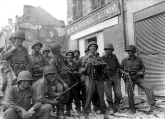 Some music and laughs of what apprears to be GI's from the 317th Regiment, Rue Arestide Briand, city centre of Argentan, August 1944.