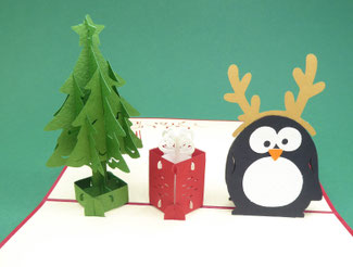 Carte de noël en pop-up avec un pingouin, un sapin et un cadeau