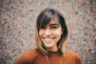 Woman looking calm and uplifted as she begins to address her challenges in therapy