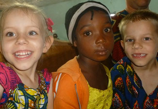 Caleb & Naomi sitting next to a girl in church