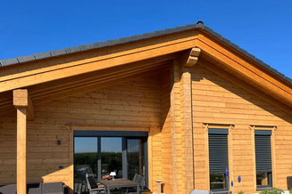 Massivholzhaus - Terrasse an der Giebelwand - Holzhaus - Blockhaus
