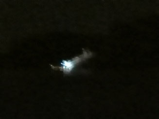 a very blurry thing that is a boat in the dark...