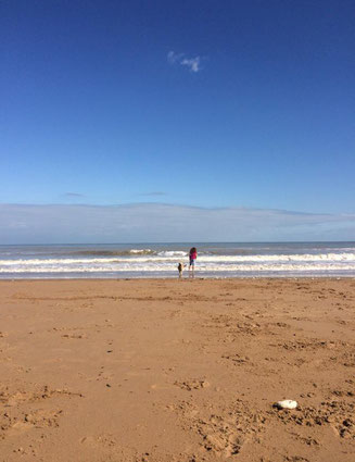 Golden sandy beach and blue sky with two figures on The Isle of Thanet, just over an hour from London, Broadstairs Apartments holiday lets company