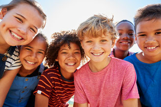 Groupe d'enfants tous souriants, ayant des réflexes archaïques bien intégrés qui leur permettent d'accéder à tout leur potentiel d'apprentissage, à une gestion sereine de leurs émotions et n'ayant pas de troubles de posture