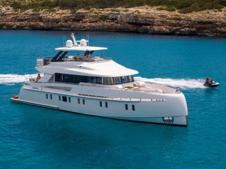 Big Luxury motor yacht in the crystal clear blue waters of Ibiza.