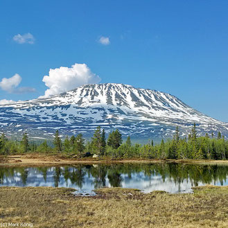 The 1883 metres high Gaustatoppen with parts of snow in front of the blue sky (June 2016)