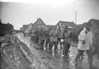 German PoW's of the 137. Geb. Jg Rgt leave Jebsheim after the battle