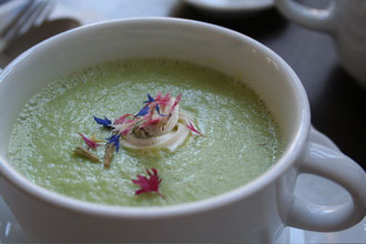 Zucchini Soup with edible flowers and almond "crème fraìche"