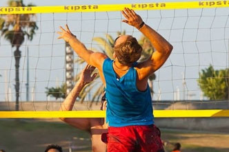 Doing sports in Barcelona. Playing beach volleyball.