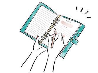 手帳にペンで書き込む指先。
