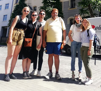 Riga free walking tour guide Philip Birzulis with a group of five smiling tourists