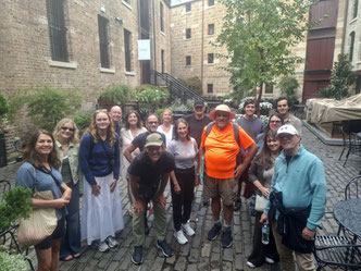 Tour guide Philip Birzulis with travellers in the Argyle Stores warehouses in The Rocks, Sydney, Australia