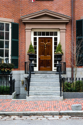 some door in the beacon hill suburb in boston ma house made out of bricks with wooden door and plants