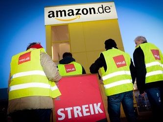 Streikende Mitarbeiter stehen vor der Betriebsstätte Amazons in Leipzig. Der mehrtägigen Streik soll heute enden. Foto: Peter Endig