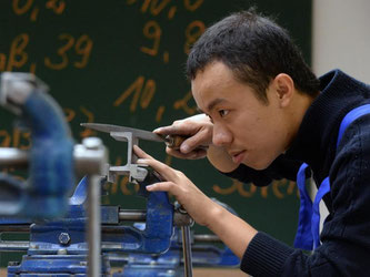 In der Metallwerkstatt des Bildungswerks der Sächsischen Wirtschaft in Chemnitz startet ein aus Vietnam stammender Lehrling in die Ausbildung zum Mechatroniker. Foto: Hendrik Schmidt/Archiv