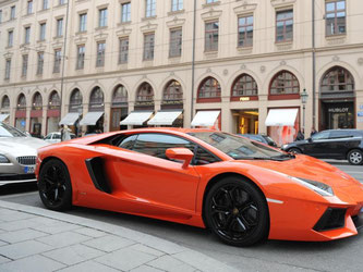 Ein orangefarbener Lamborghini auf der Maximilianstraße in München. Solche Luxusgüter sind derzeit hoch im Kurs. Foto: Andreas Gebert