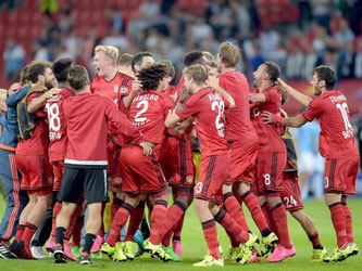 Die Spieler von Bayer Leverkusen feiern den klaren Sieg und den Einzug in die Champions League. Foto: Federico Gambarini