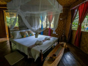 nypa style resort, Rainbow villa, accommodation good for 4 people max, bedroom queen-size bed, 2 extra single beds, combination of bedroom and lounge areas, accommodation in Camiguin, Philippines