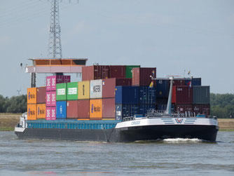 Inland waterway vessels carrying containers.