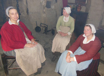 Three Women Huddled around a Smoky Fireplace Hearth