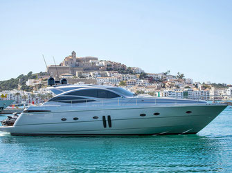 Pershing yacht in the water, infront of the old town of Ibiza