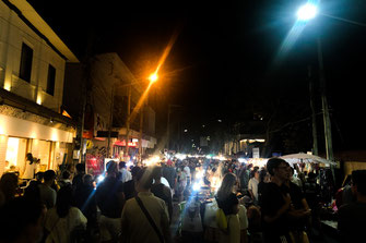 A street lined with food stalls in the evening in Chiang Mai.
