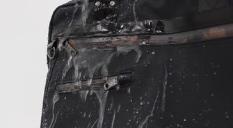 Water being poured onto ETUBY's water-resistant bag fabric