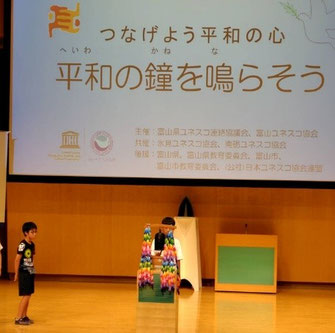 平和の鐘を突く参加者