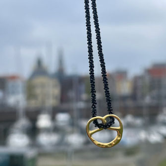  Detailaufnahme einer filigranen Brezelkette, handgefertigt aus 925 Silber in Stuttgart inspiriert von unserer schwäbischen Backwaren-Tradition. Fotografiert in Brügge, Belgien.