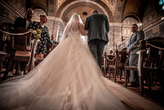 Ein Vater führt seine Tochter zu einer Hochzeit in die Kirche