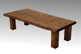 Baumstamm Couchtisch aus einer Stammbohle Eiche mit außenstehenden Holzbeinen.
