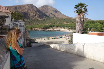 enjoying the view of the beach and the mountains in the background