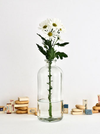厚みのあるガラスの花瓶「Jardin Flower Vase 25cm」。ほのかに緑がかったガラスが特徴で、保存瓶のような素朴な雰囲気。枝物や一輪挿しにぴったりで、大ぶりの花や葉も安定して飾れます。シンプルで使いやすいデザイン。