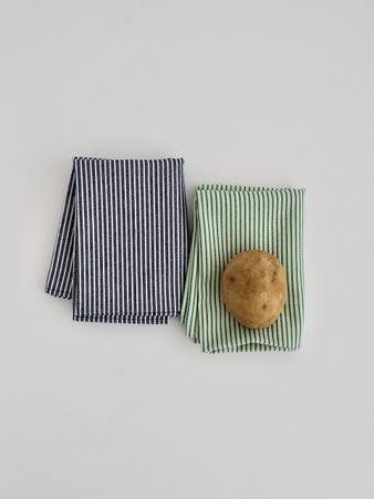 落ち着いたグリーンのストライプが美しいコットン製ティータオル。食器拭きや鍋敷き、野菜の保存などキッチンで多用途に使える上質な一枚です。