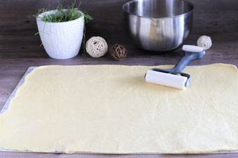 Teig mit dem Teigroller auf der Teigunterlage von Pampered Chef ausrollen