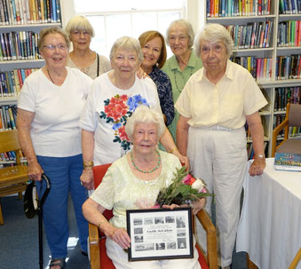Group photo of past Friends of Whelden Library members during a library celebration.