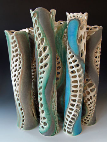 Group of pierced tall cylinders evocative of sea weed