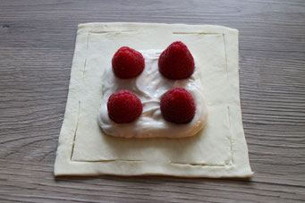 puff pastry square with cream cheese filling and raspberries