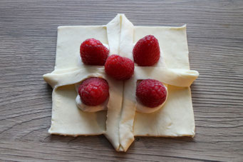 puff pastry square with cream cheese filling and raspberries