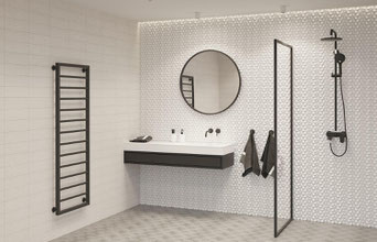 Step into your dream bathroom with this beautiful renovation, featuring a bright and spacious design with a stunning round mirror over a sleek black and white vanity.